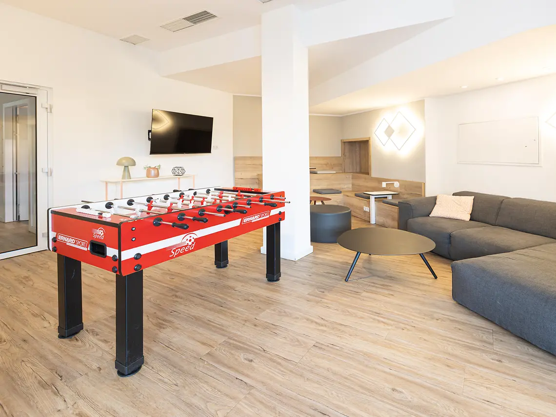 Student games lounge in accommodation in Münster with table football, sofa seating and TV