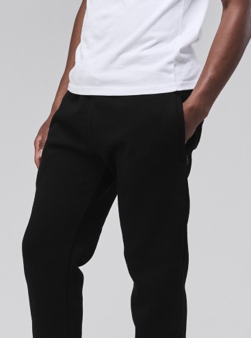 Man wearing Sunday Superior black sweatpants