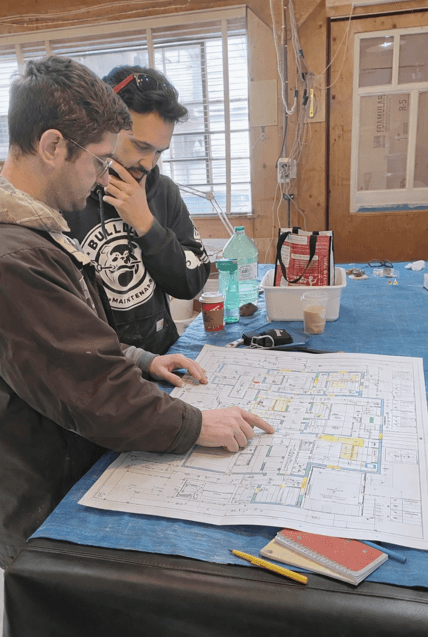 man drawing on dry-erase board