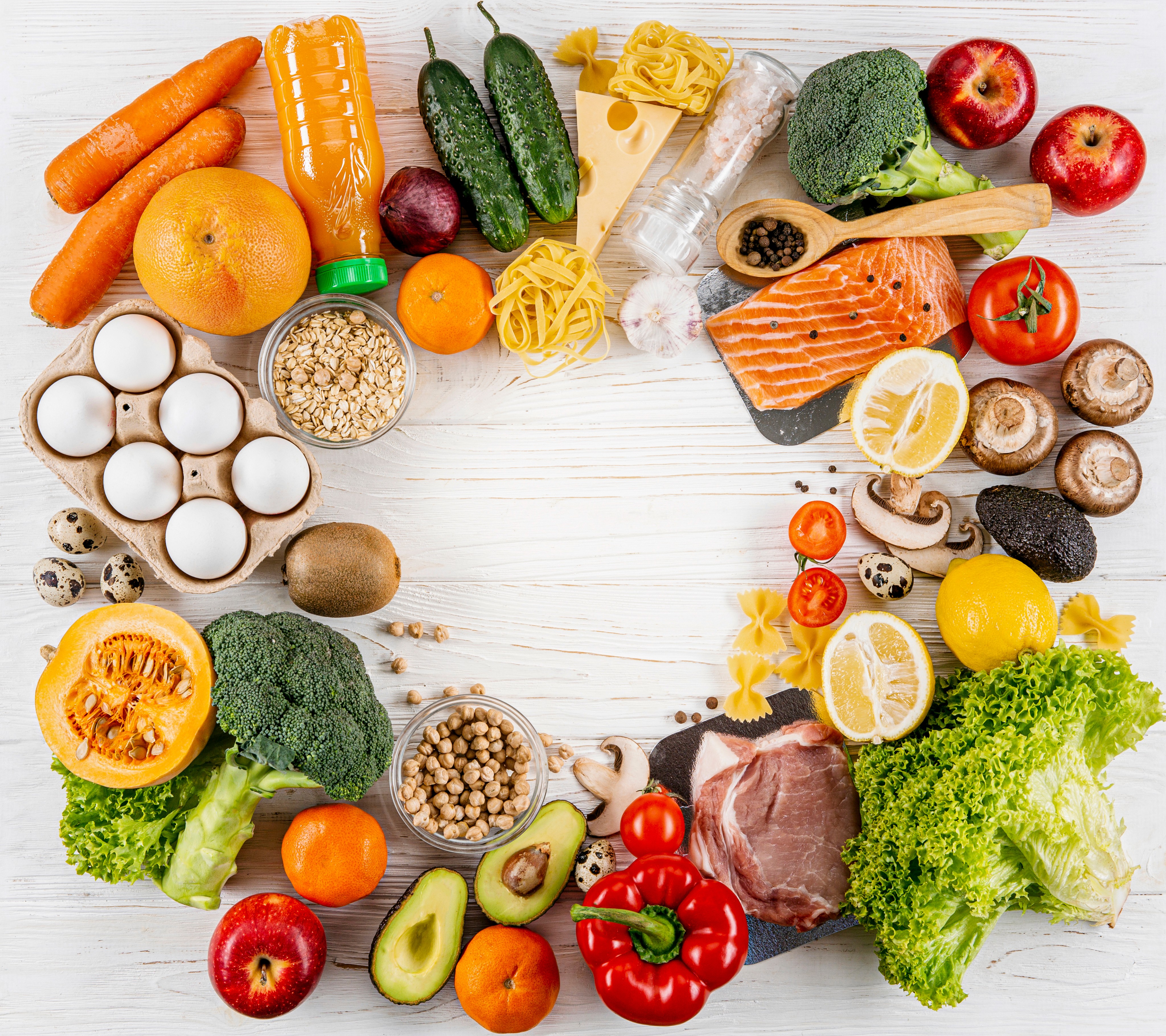 Healthy food ingredients surrounding the Kaleidoscope Kids logo, showcasing childcare nutrition and balanced meals at our Brisbane centres.
