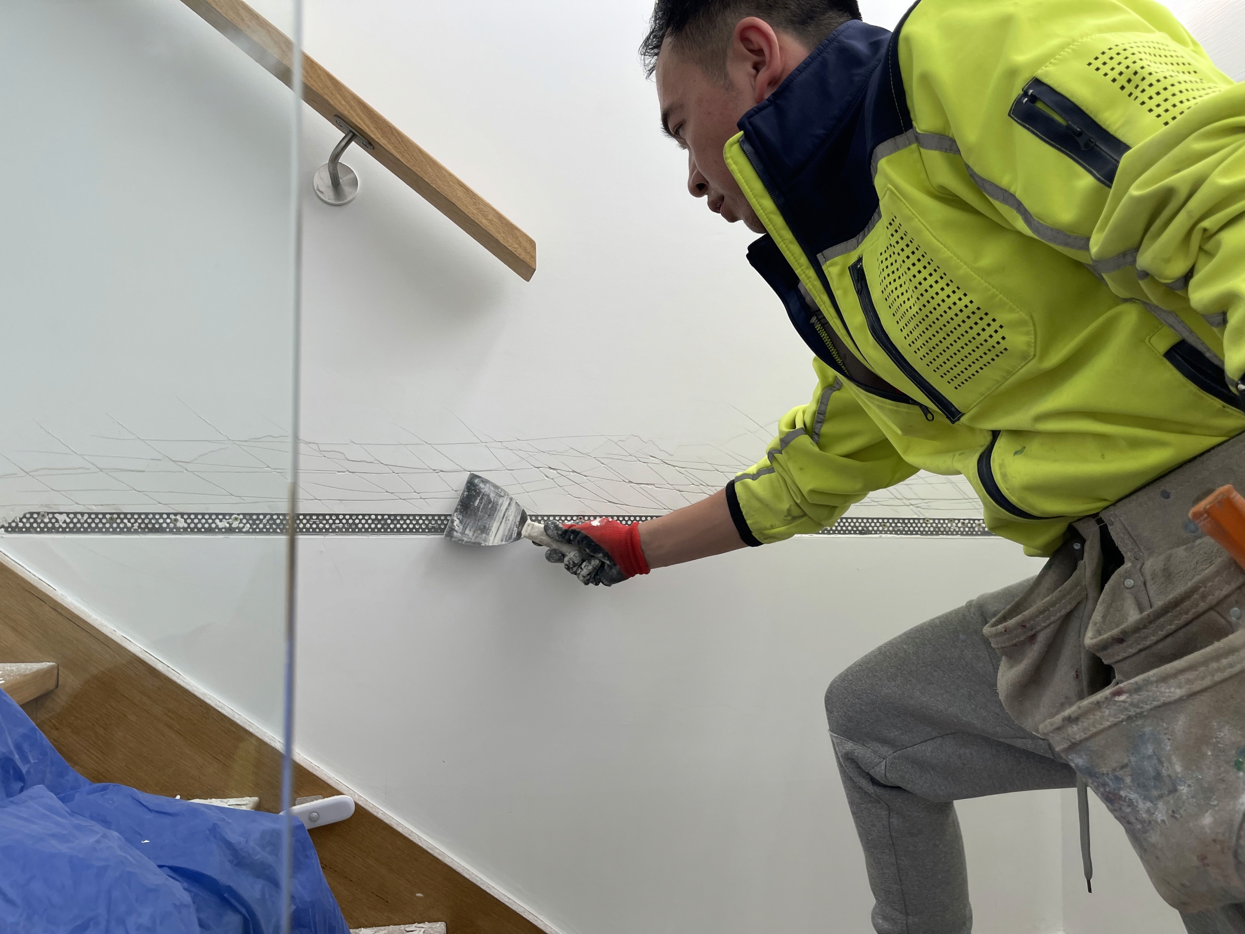 Modern bathroom featuring wooden cabinetry, a bathtub, a sleek sink, and natural light from a window.