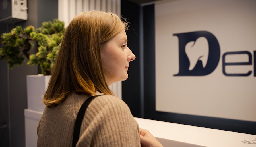 a dental patient waits at the reception of the dental clinic