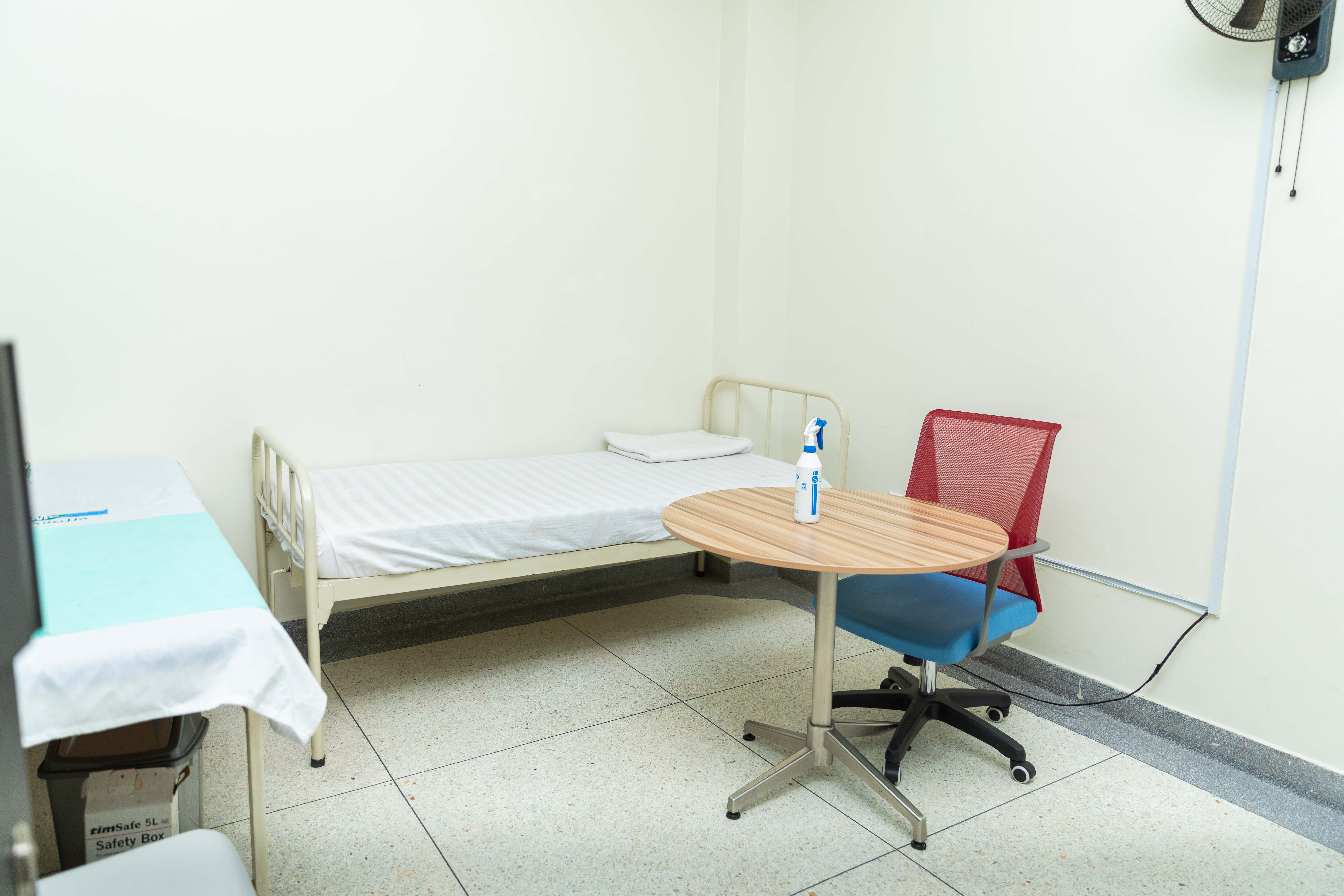 Two cheerful students are balancing books on their heads, smiling and laughing