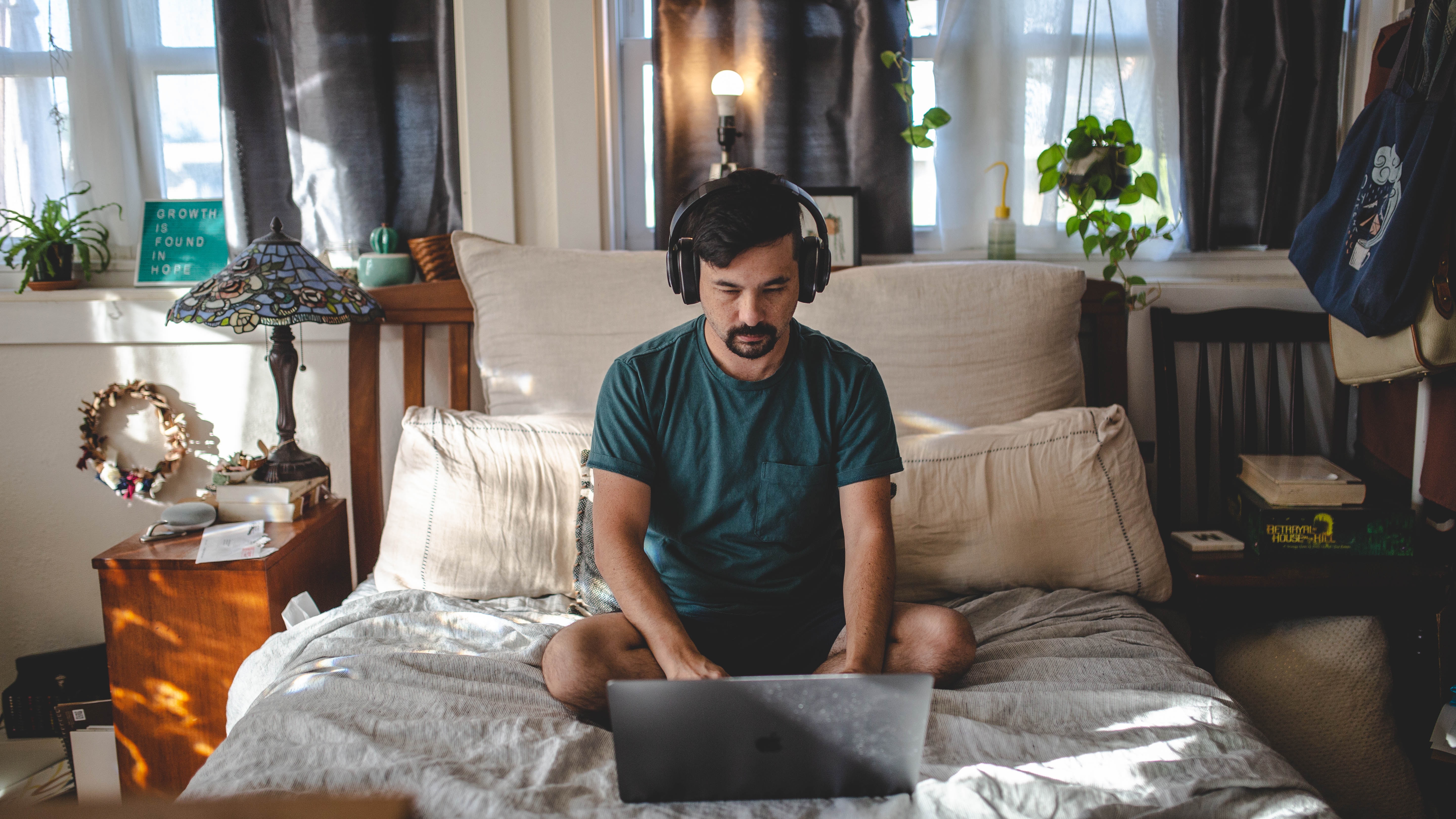 man researching on laptop about how to make ai cover songs