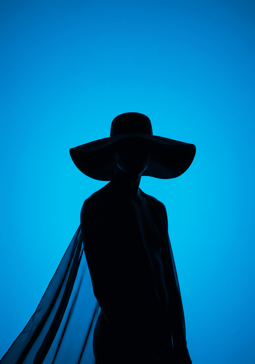 women in black againt blue background