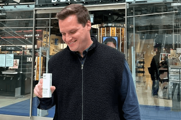 Black and white portrait of a smiling person with curly hair