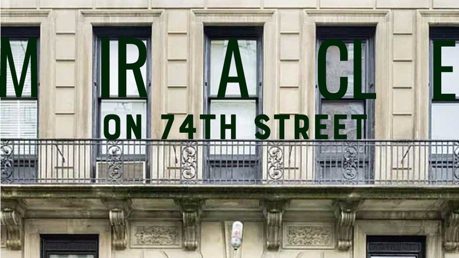 The facade of an old building with large windows and the words "Miracle on 74th Street" displayed prominently.