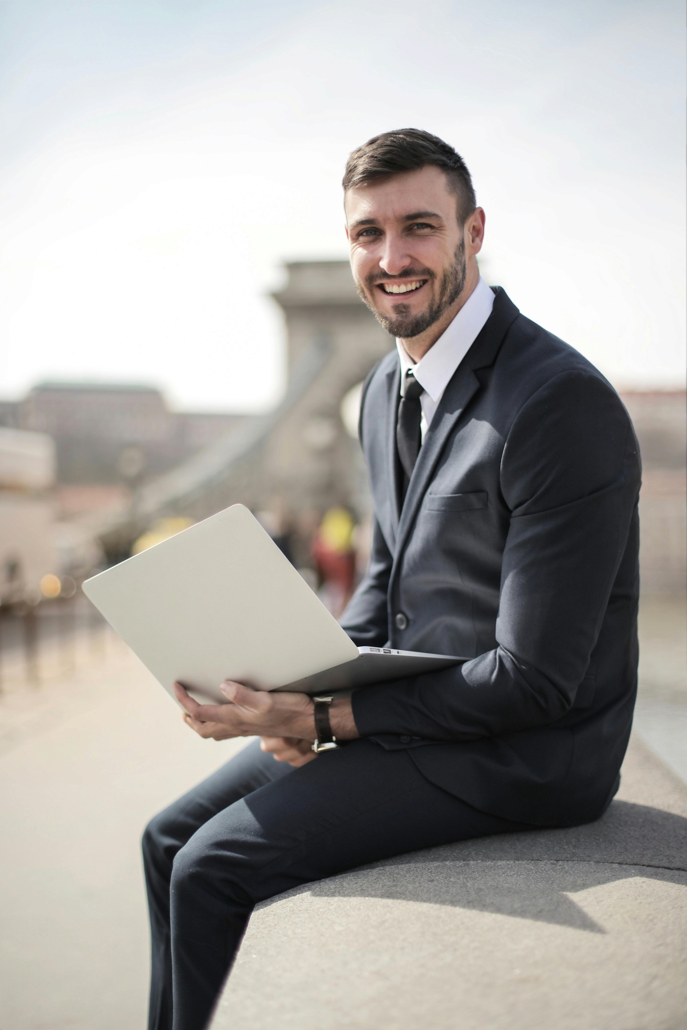 man wearing suit with laptop