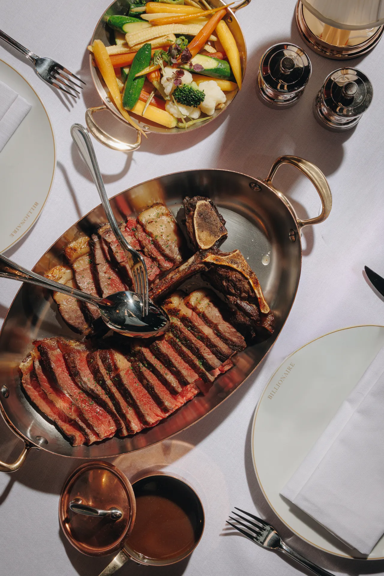 Sliced steak served in a copper pan at Billionaire Dubai