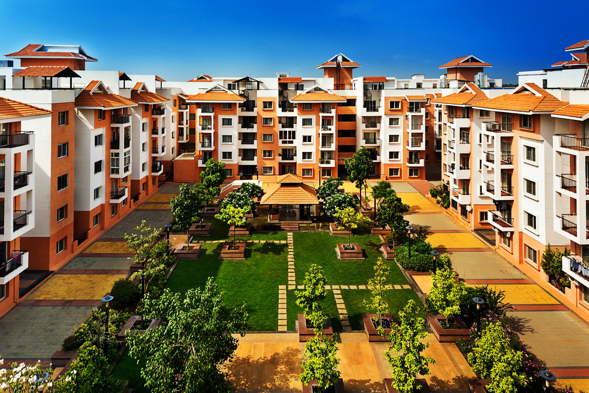 Aerial view of a winding road cutting through rocky terrain and sandy landscape.