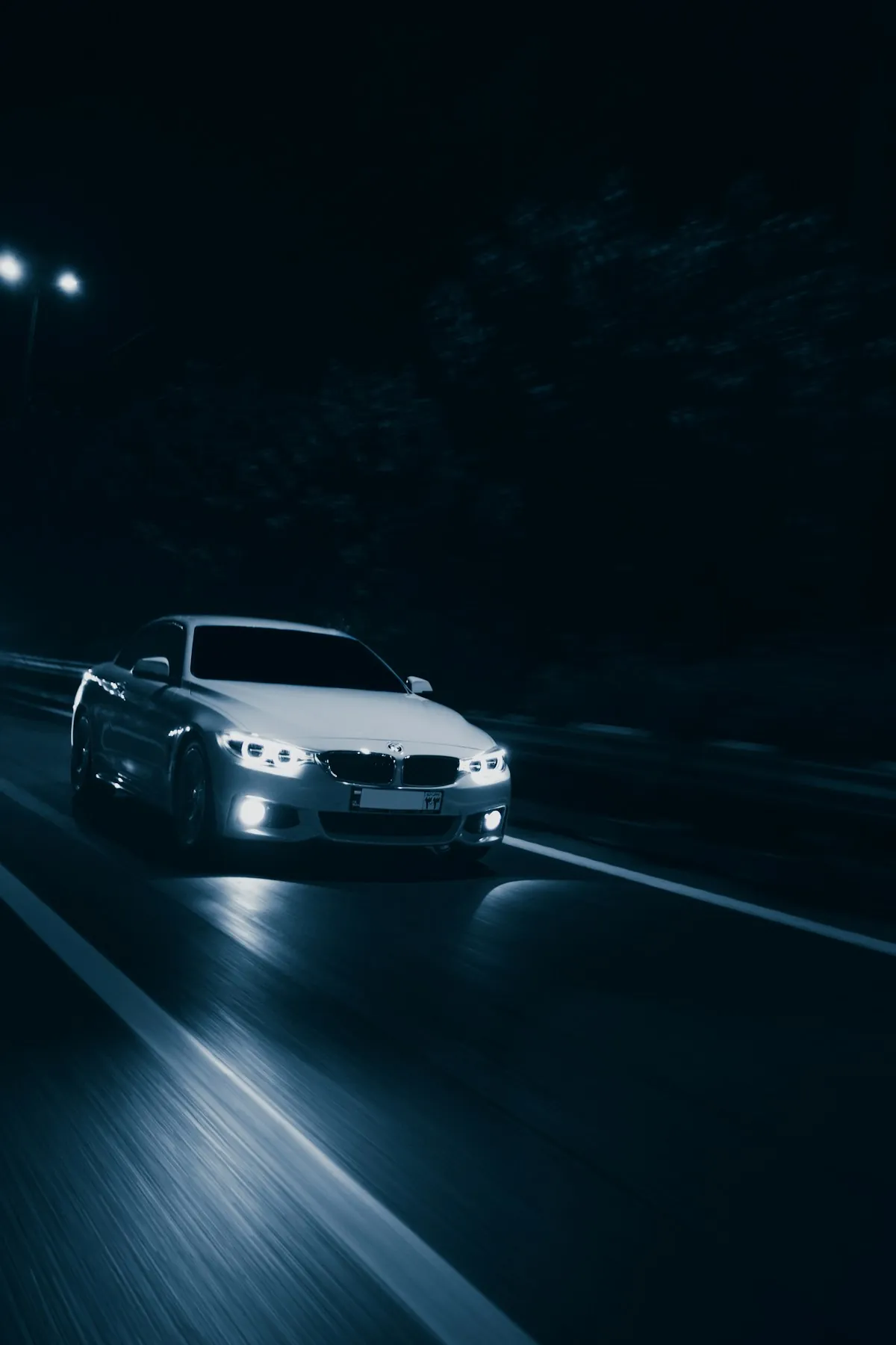 Car headlights on a road at night