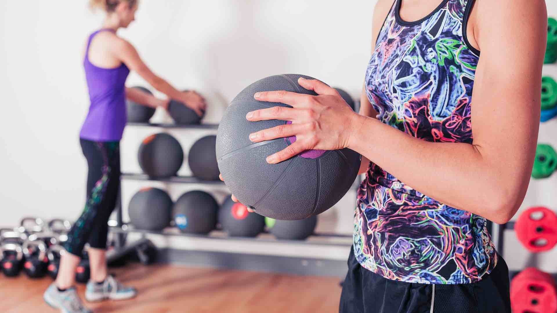women holding medicine ball