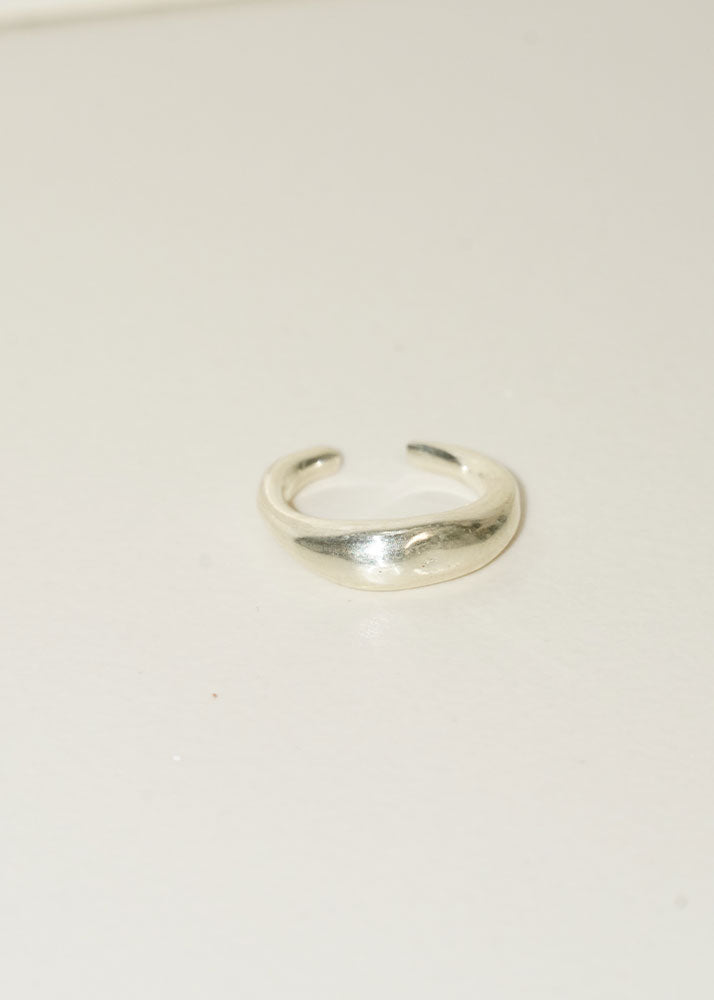Silver ring on a light beige background