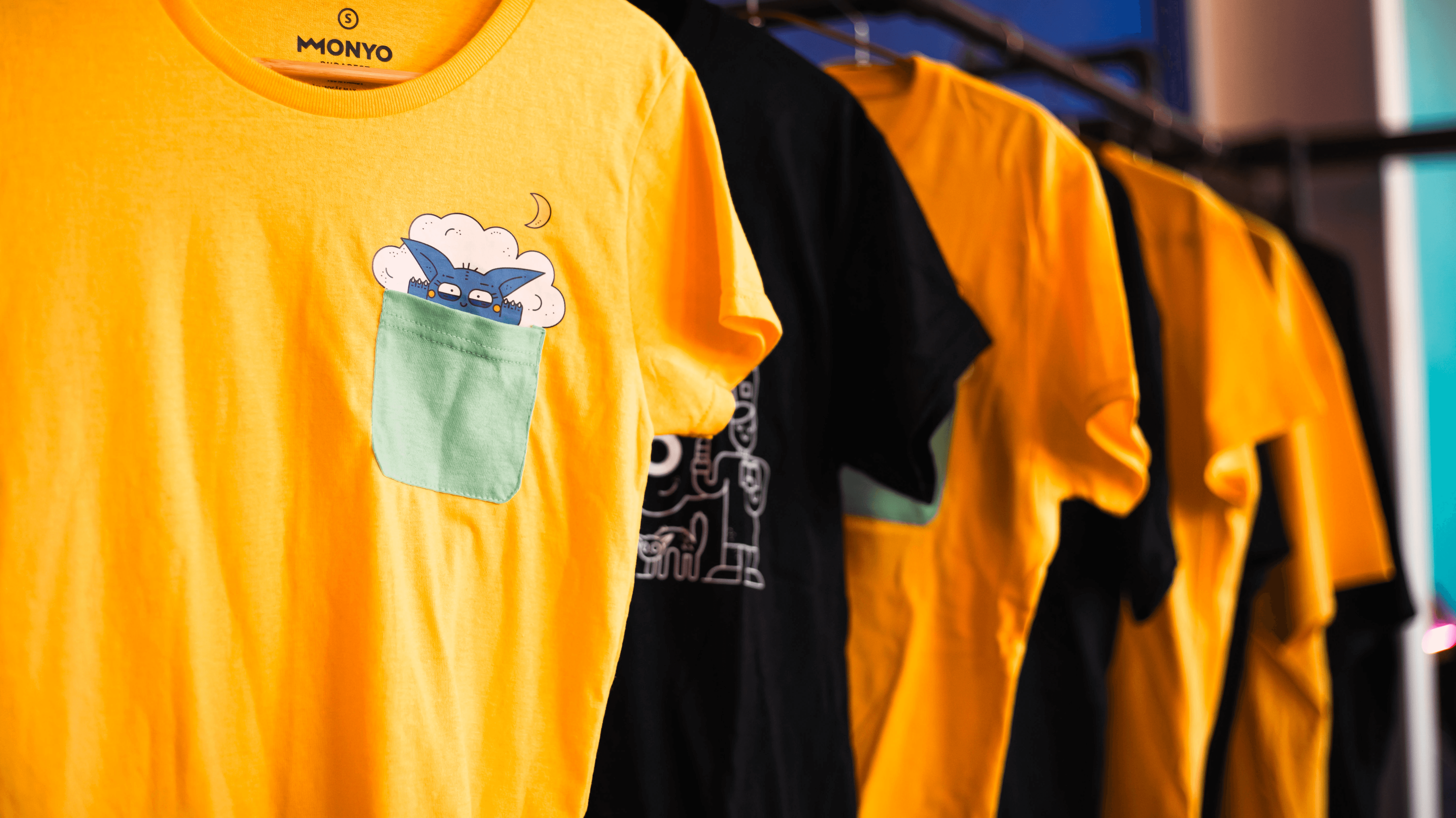 Woman in blue hat and sweater sitting on couch with laptop.