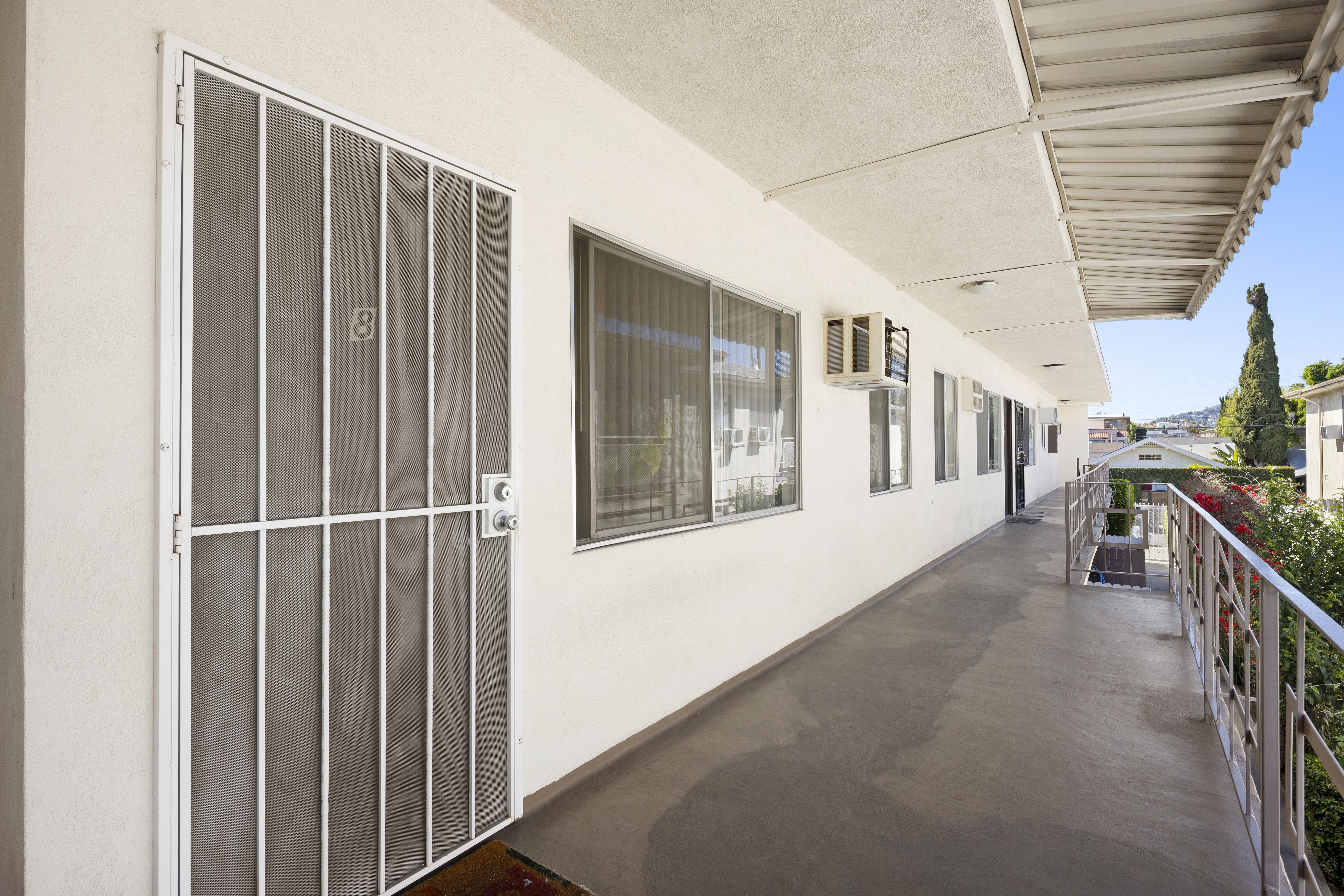 Second-floor walkway corridor with unit entrances and railing at 1336 N Citrus Ave.