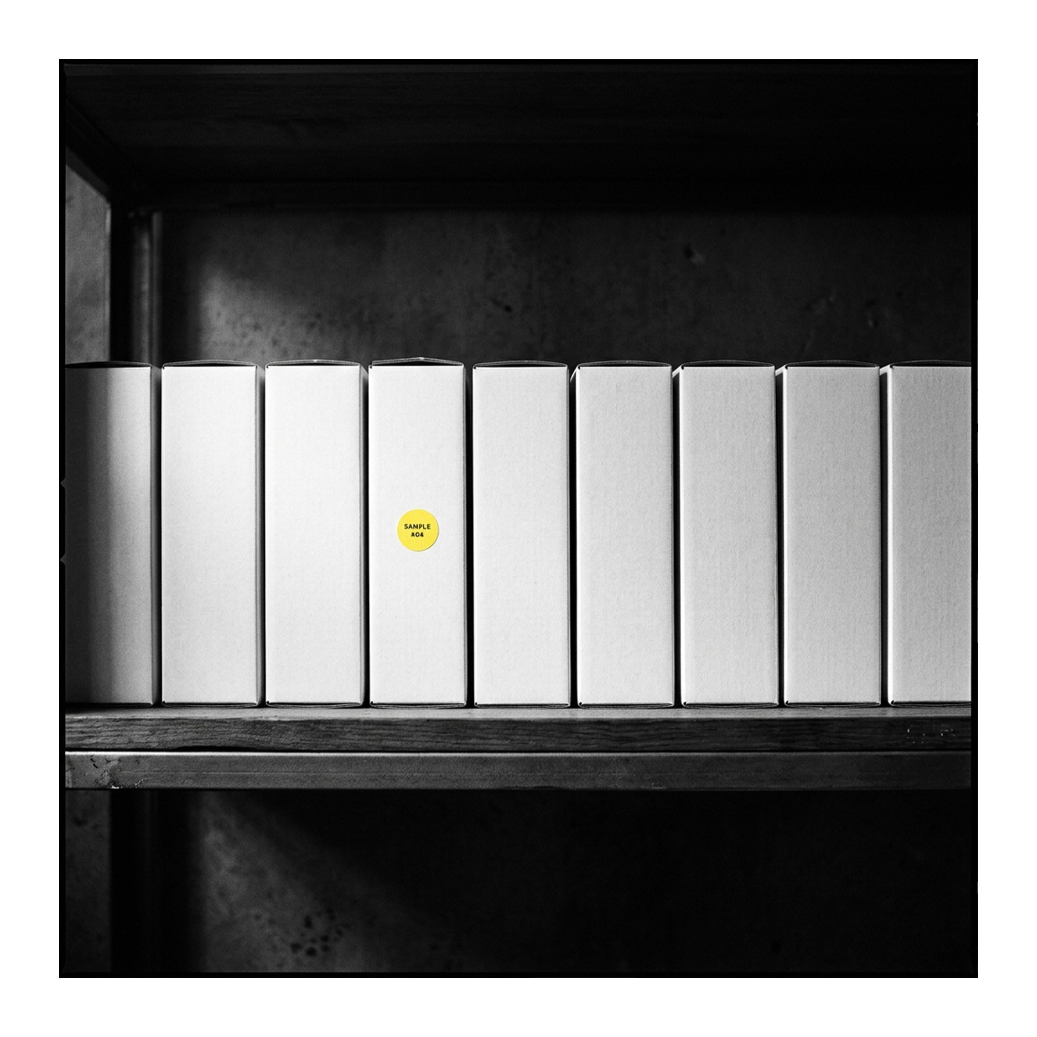 White books on a shelf with one yellow dot illustrating brand differentiation by Marji Studio.
