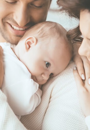 family hugging their baby