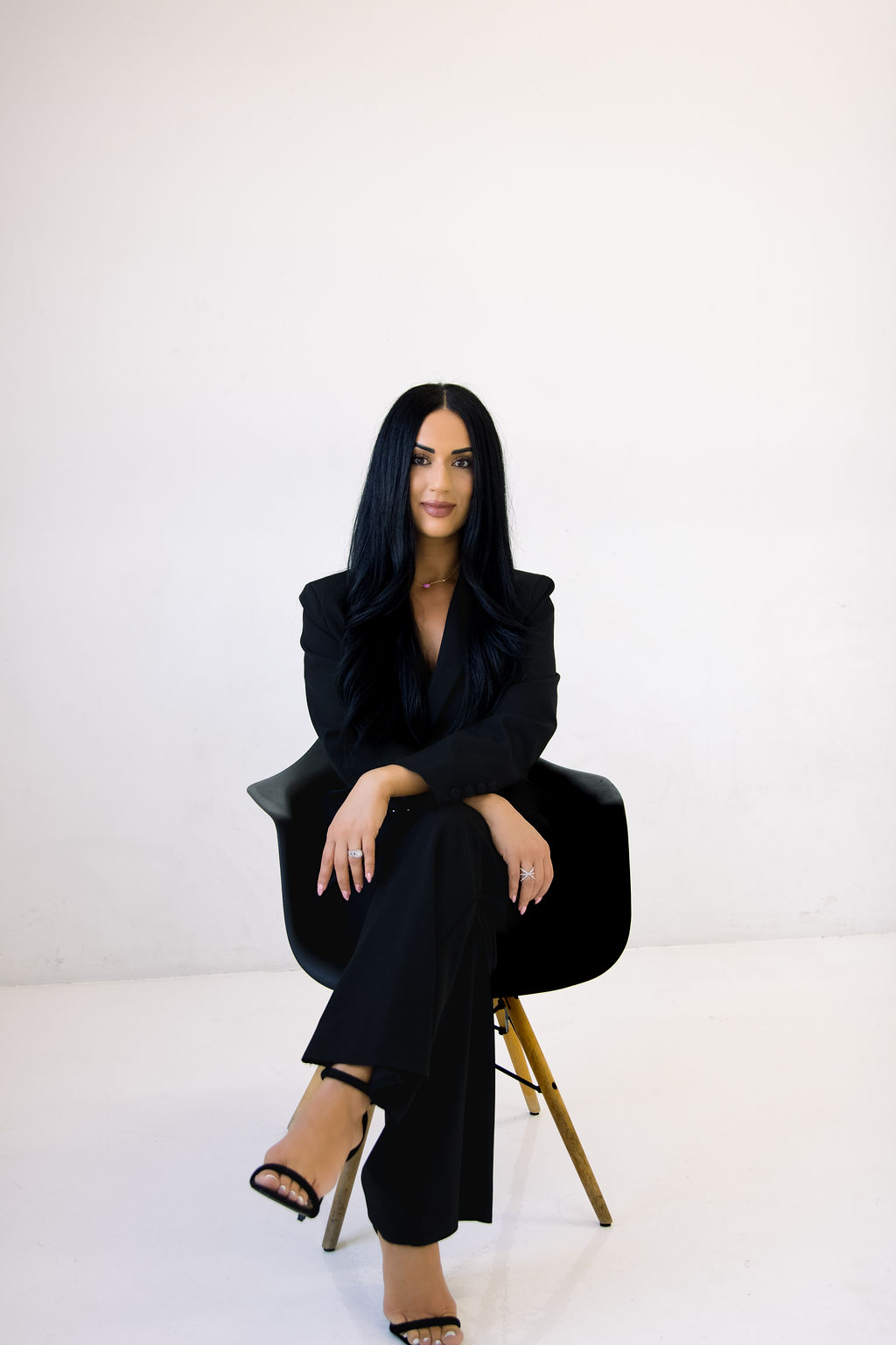 A vibrant bridal bouquet featuring a mix of red, pink, and purple flowers.