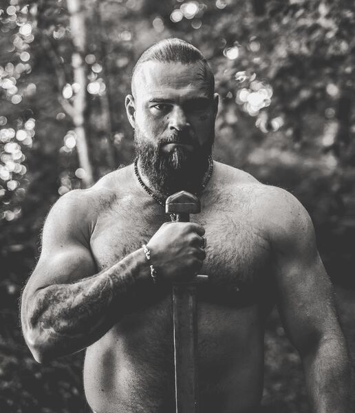 A gradient image transitioning from dark black to light gray tones.