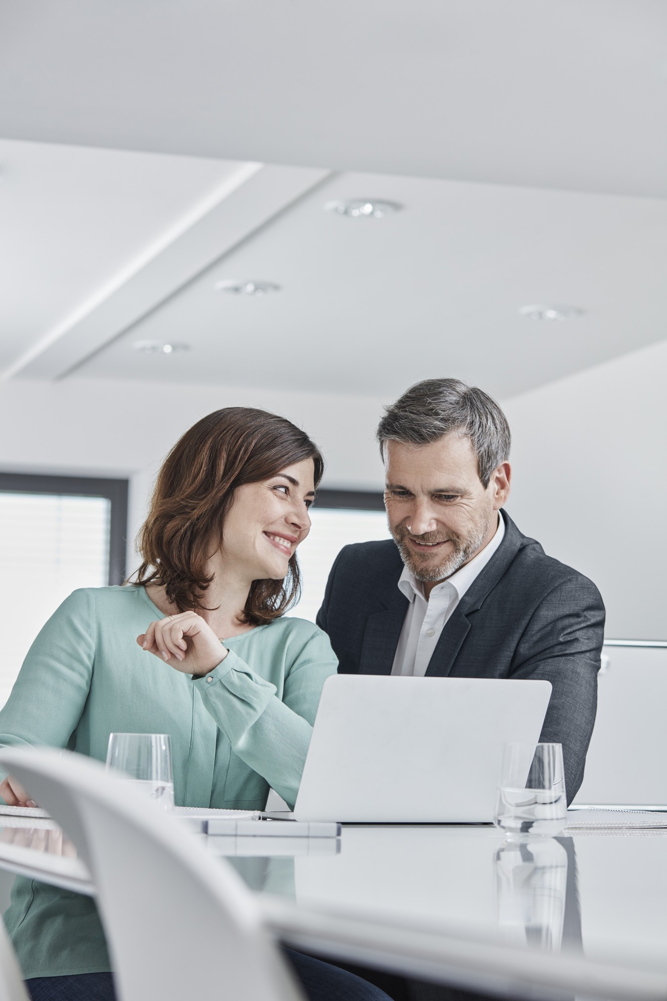 Business colleagues working together with laptop in office