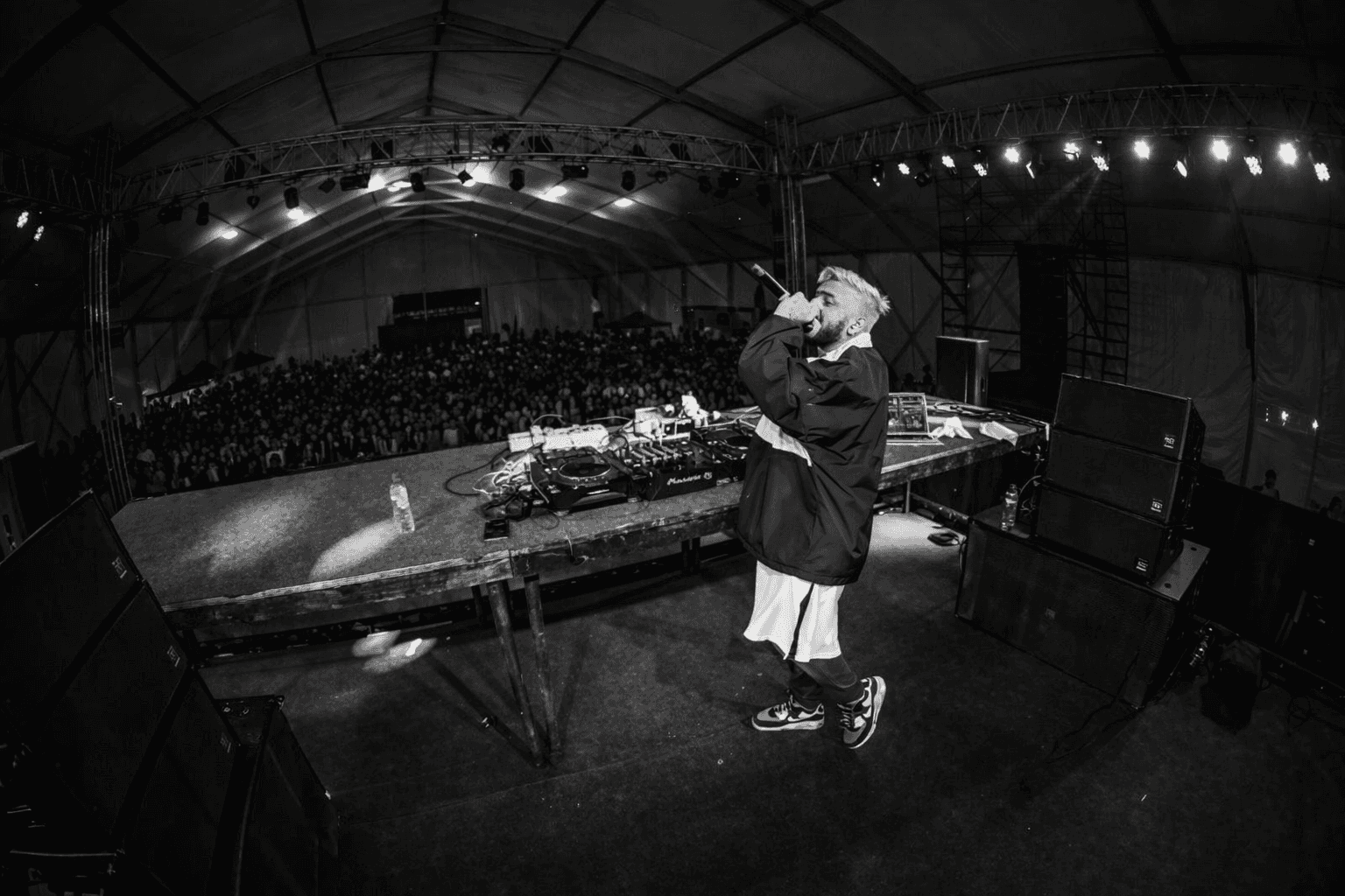 White branded cap with turquoise logo placed on fresh lemons in a red bowl