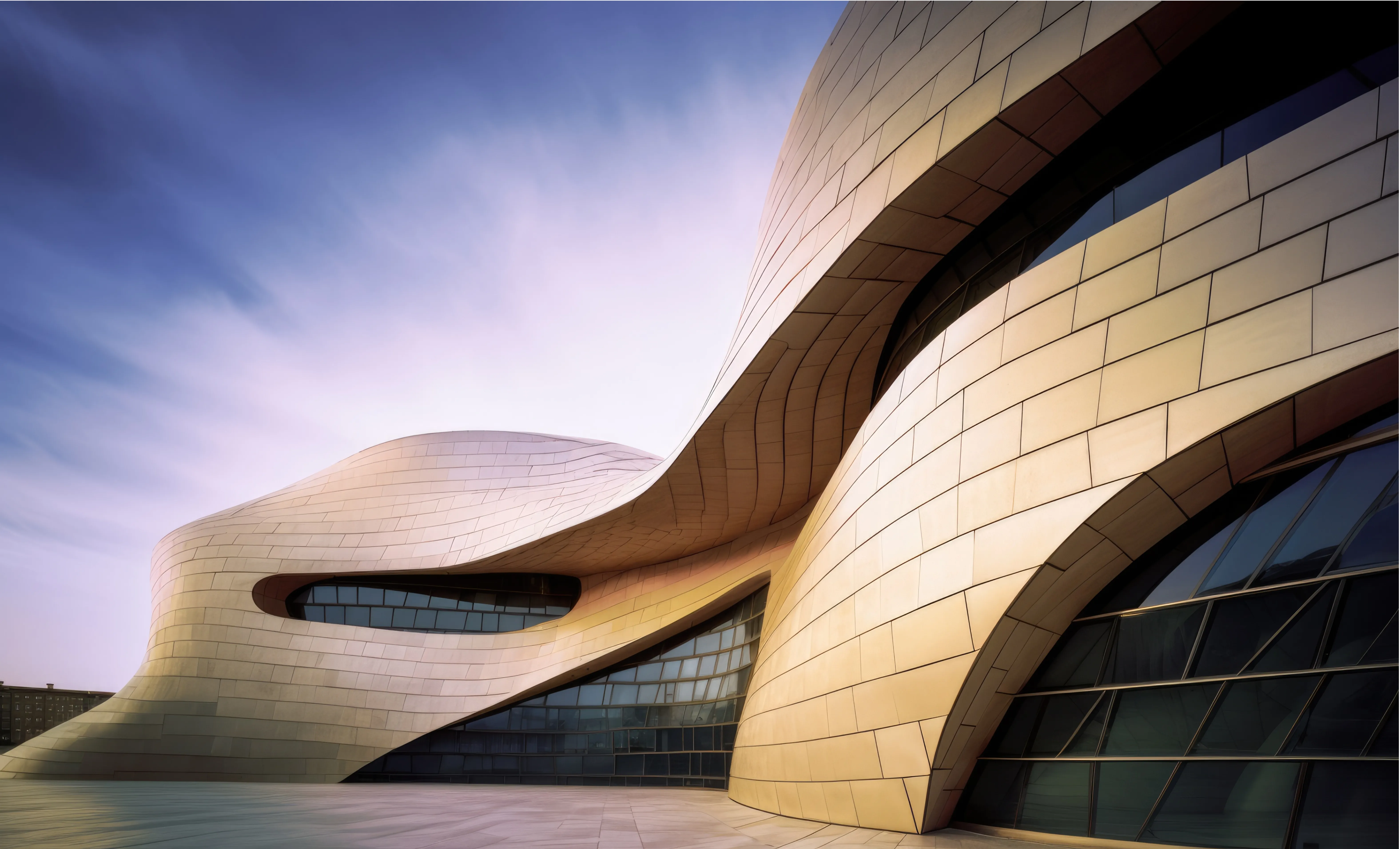 Futuristic curved building exterior with gold metallic tiling and organic architectural shapes under a soft sky.
