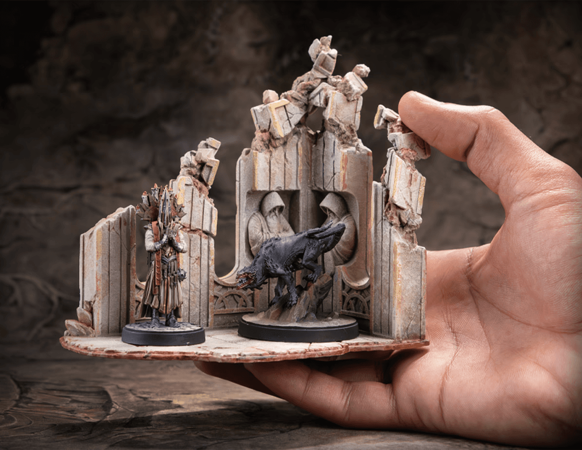 A person fingers reaching out to a miniature of an Troll