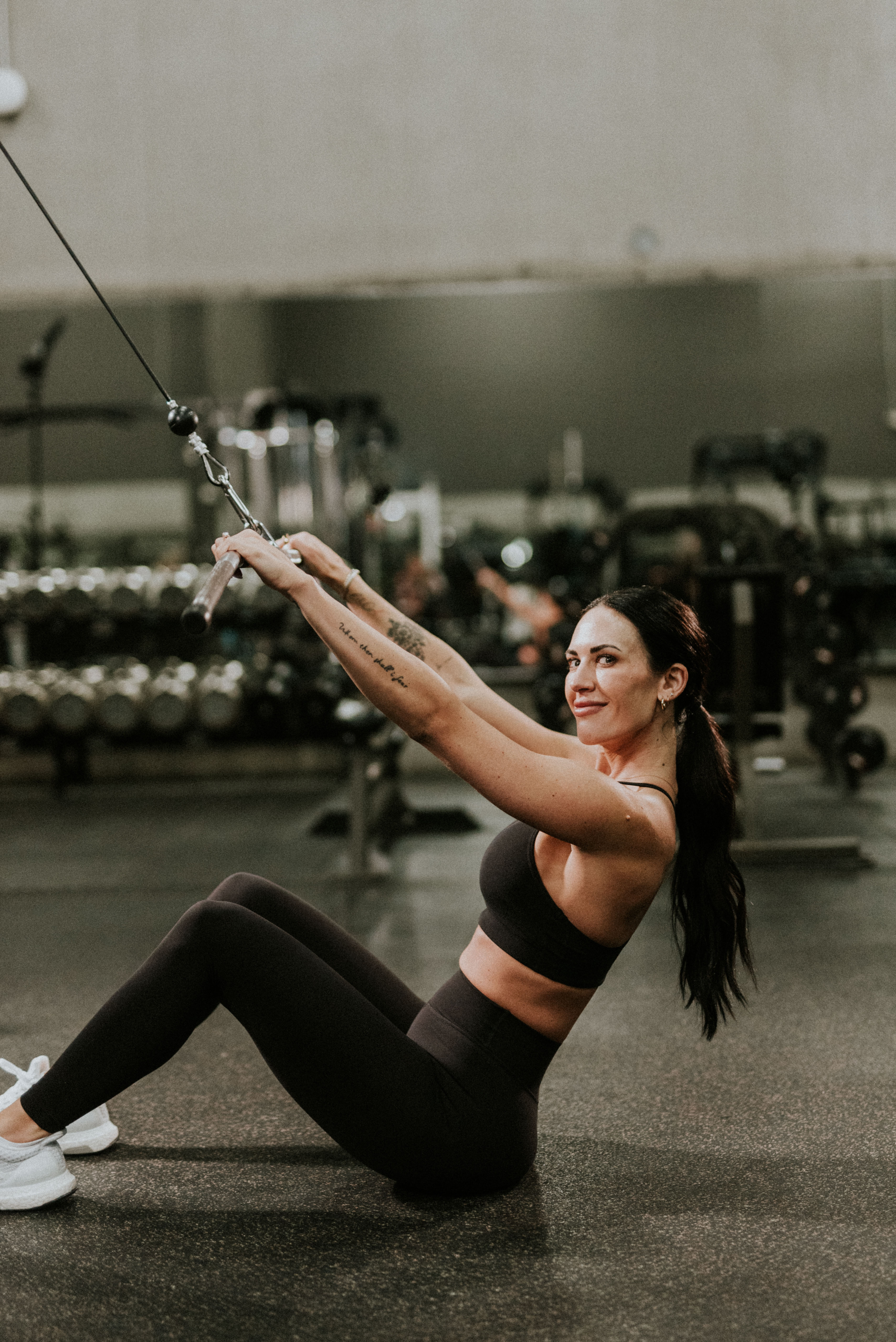 Coach Shae, personal trainer, looking to the side confidently in a fitness studio