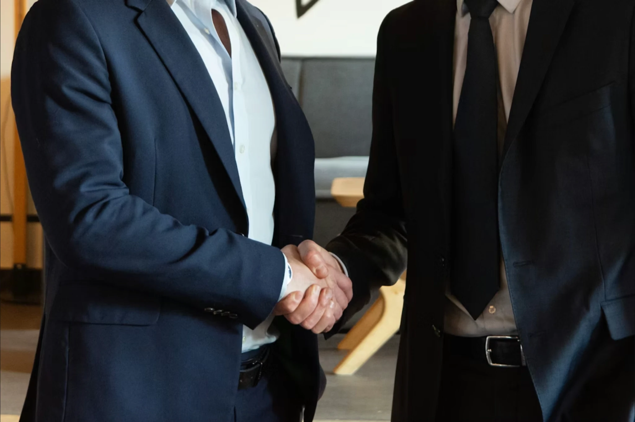 Two professionals shaking hands representing the firm's M&A and capital markets advisory relationships across Europe