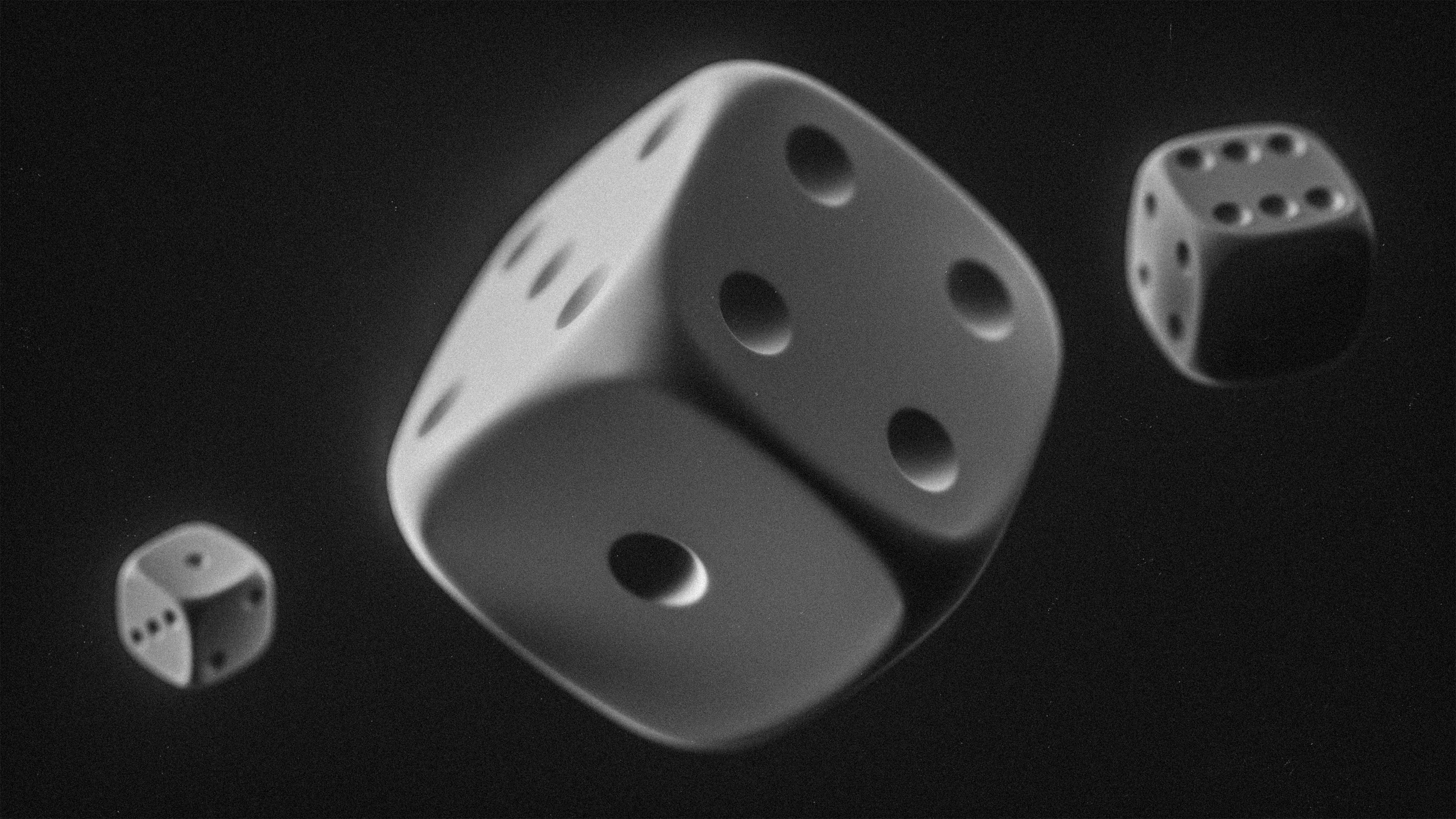 Three dice floating against a black background