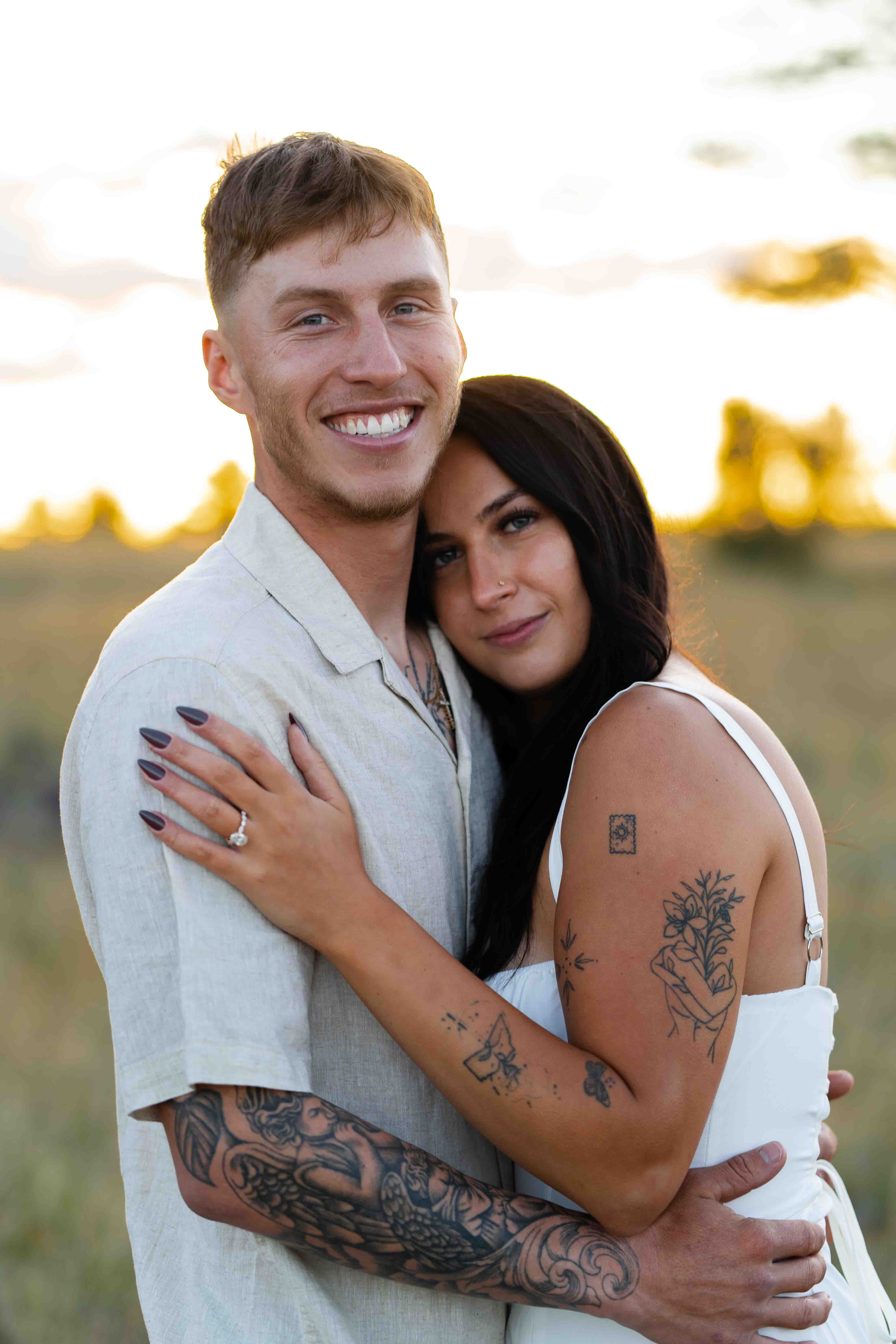 Engagement Photo in Phoenix Arizona. Cute couple poses in a field.