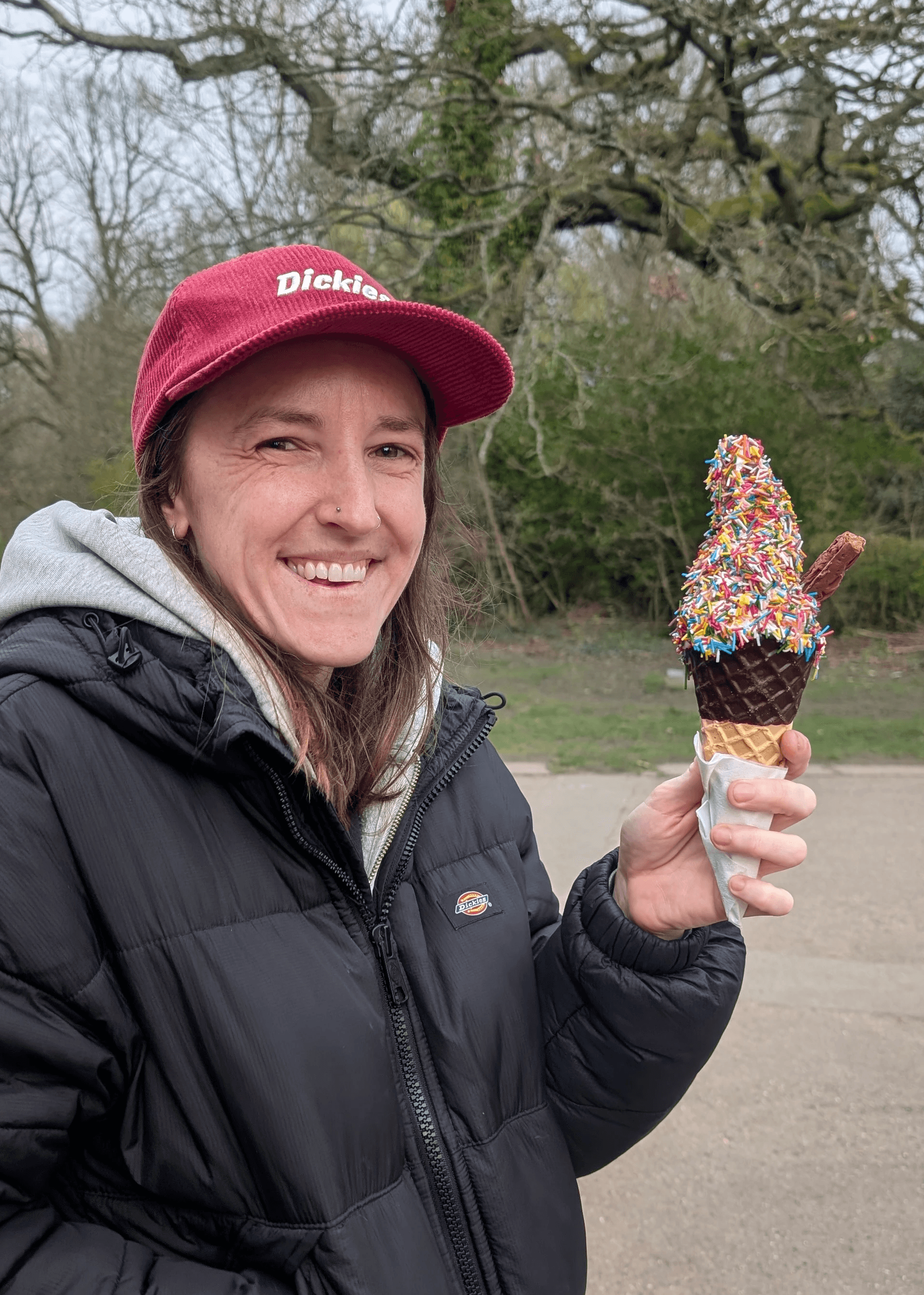 headshot of female holding an icecream in a park