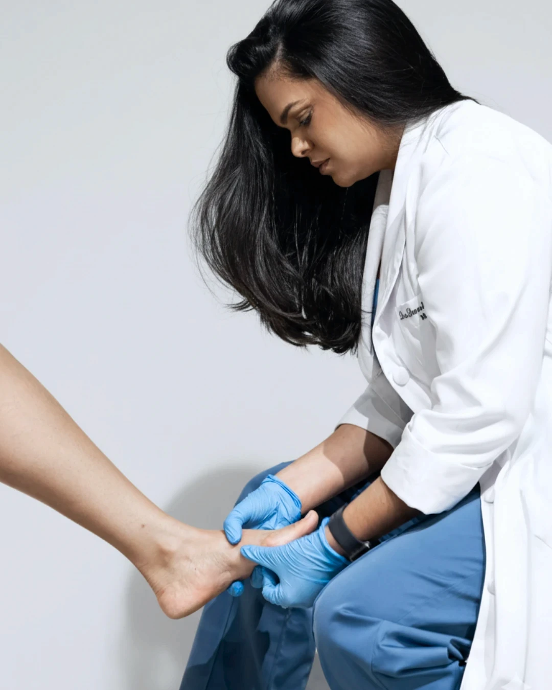 woman sitting around table holding tablet