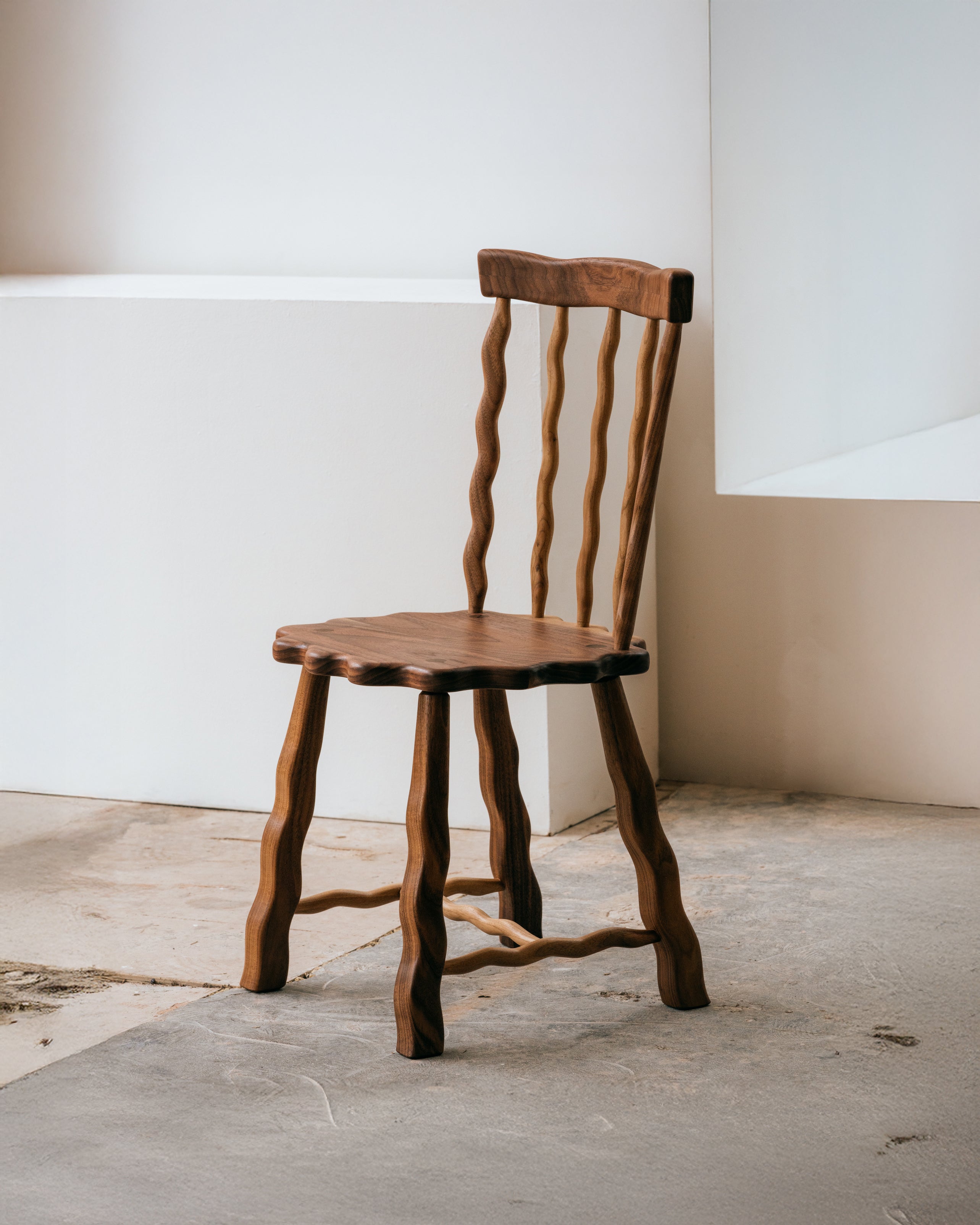 Walnut Windsor dining chair in a neutral coloured room