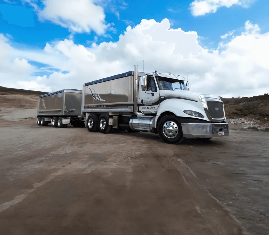 Large truck and trailer parked in a sand quarry