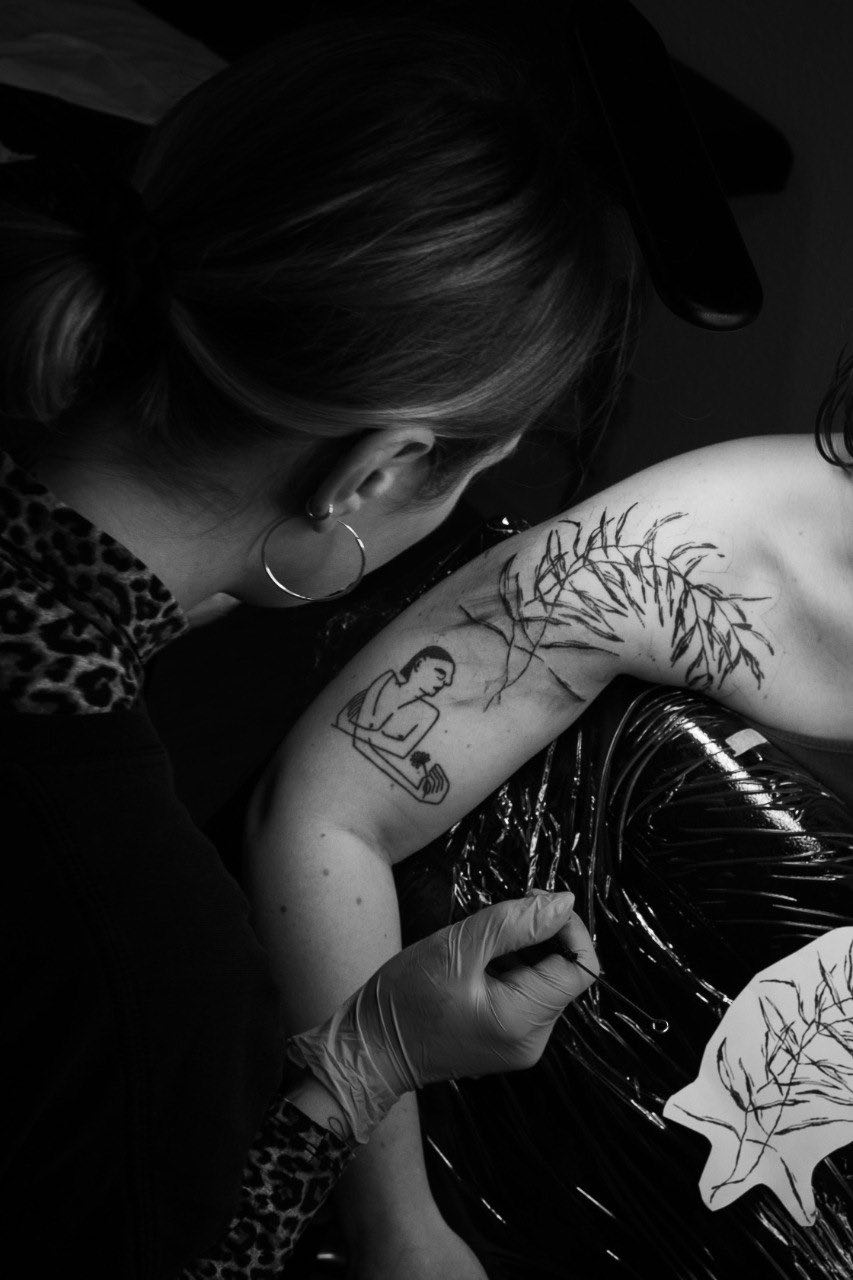 image of tati of checking her tattooing