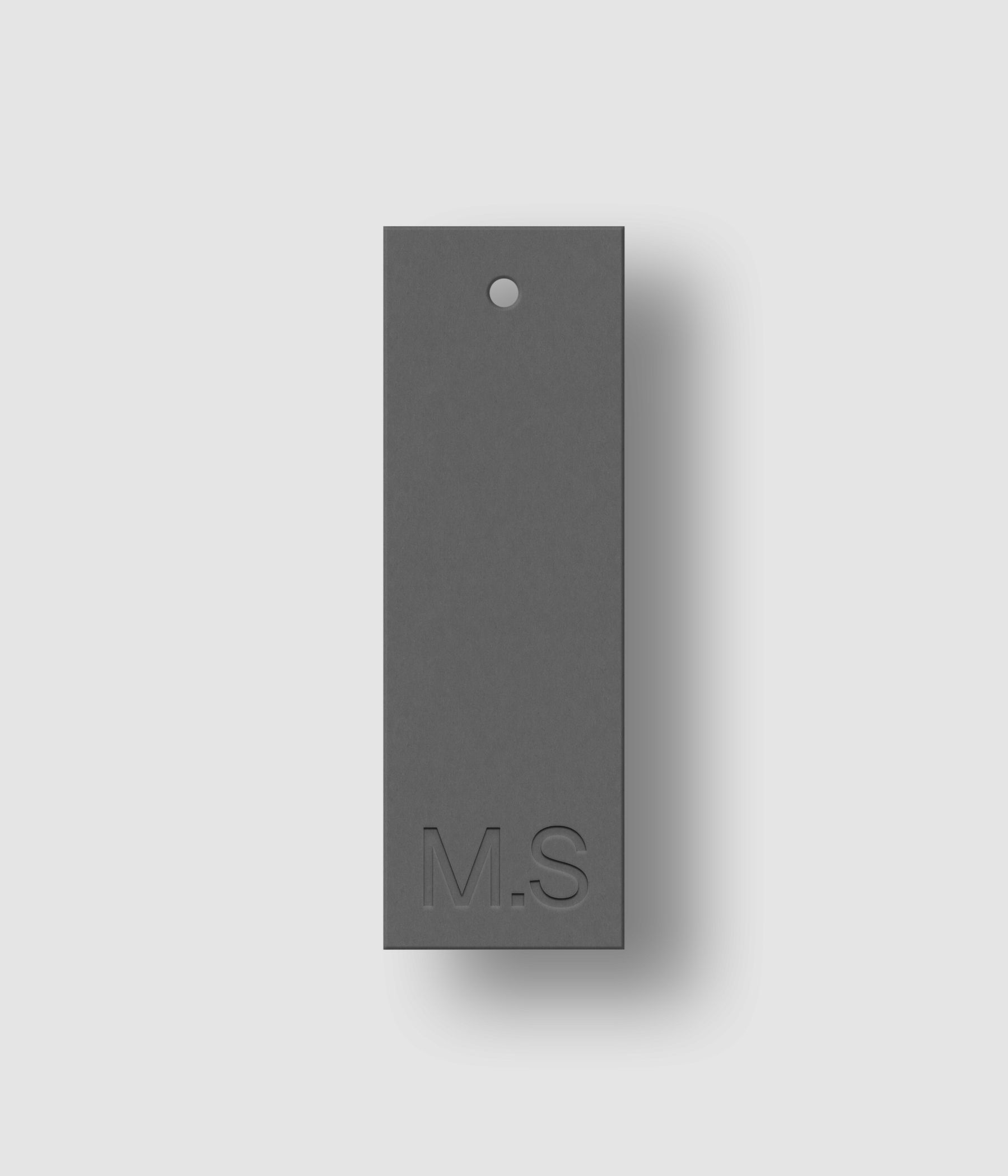 Gray 1x3 clothing label mockup on white background with natural shadow depth and debossed text effect for Photoshop download psd