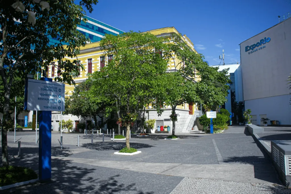 Large yellow building with blue sky and trees.