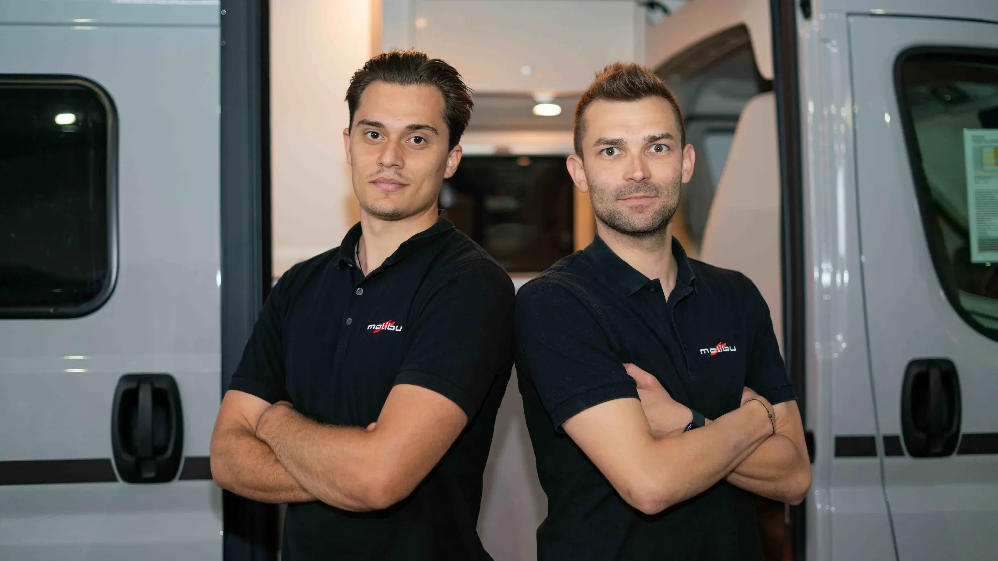 Two chefs behind the kitchen counter