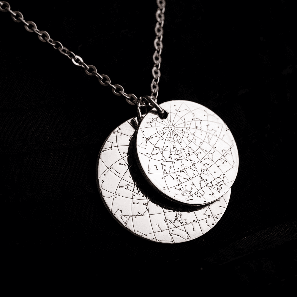 Two layered silver Night Sky Star Maps hanging from a silver chain.