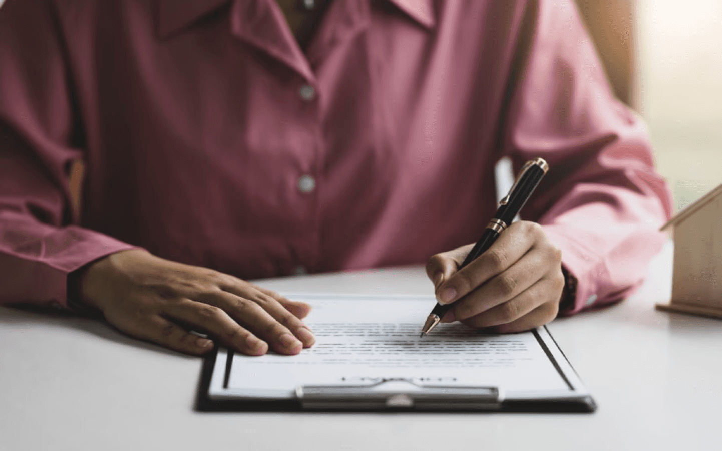 person signing a document