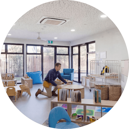 man moving table in childcare centre