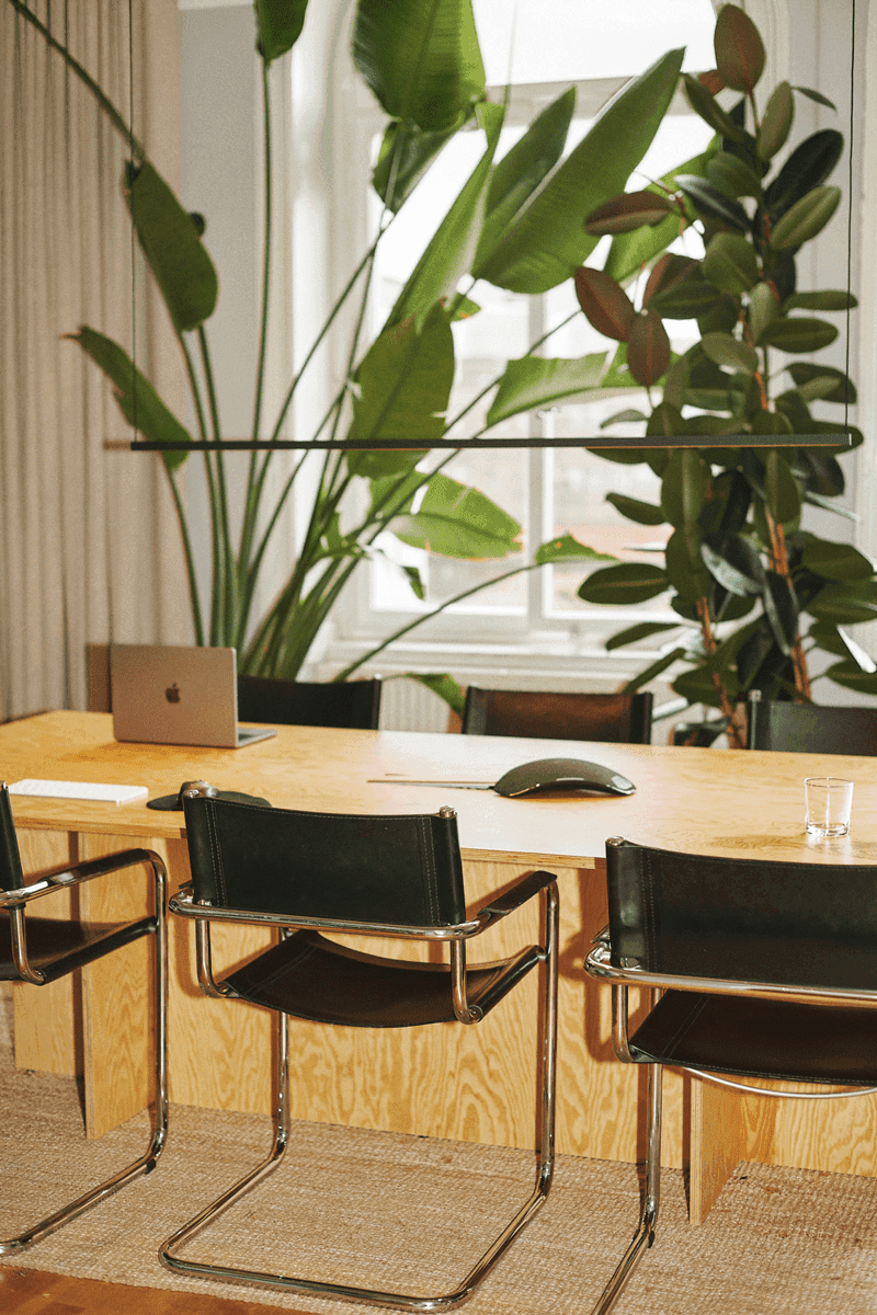 Heads' headquarters meeting room with wooden table and black chairs