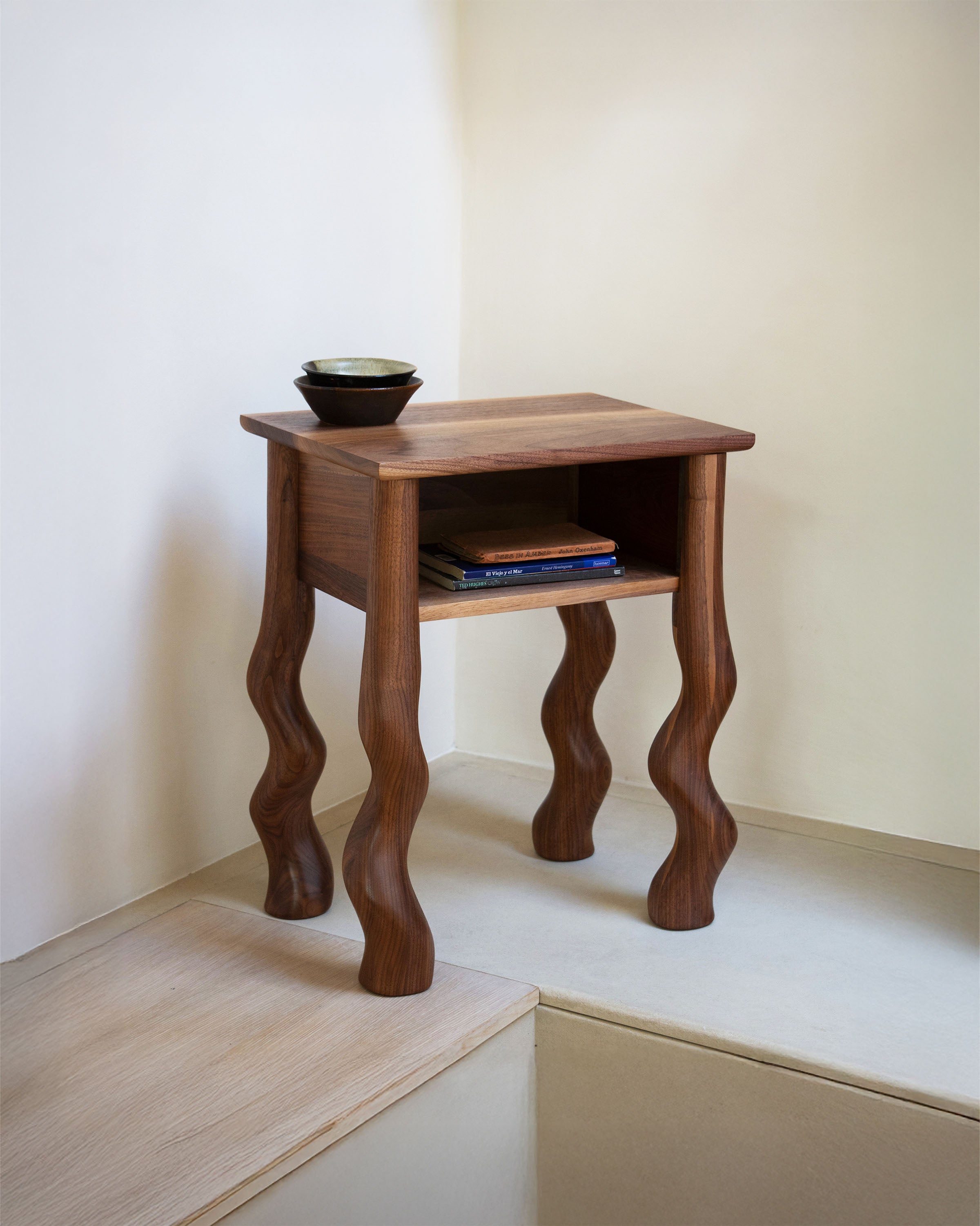 Dancing Bedside Cupboard in Walnut with books and bowl