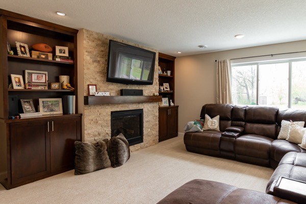 Large family room with fireplace mantle tv dark wood shelving