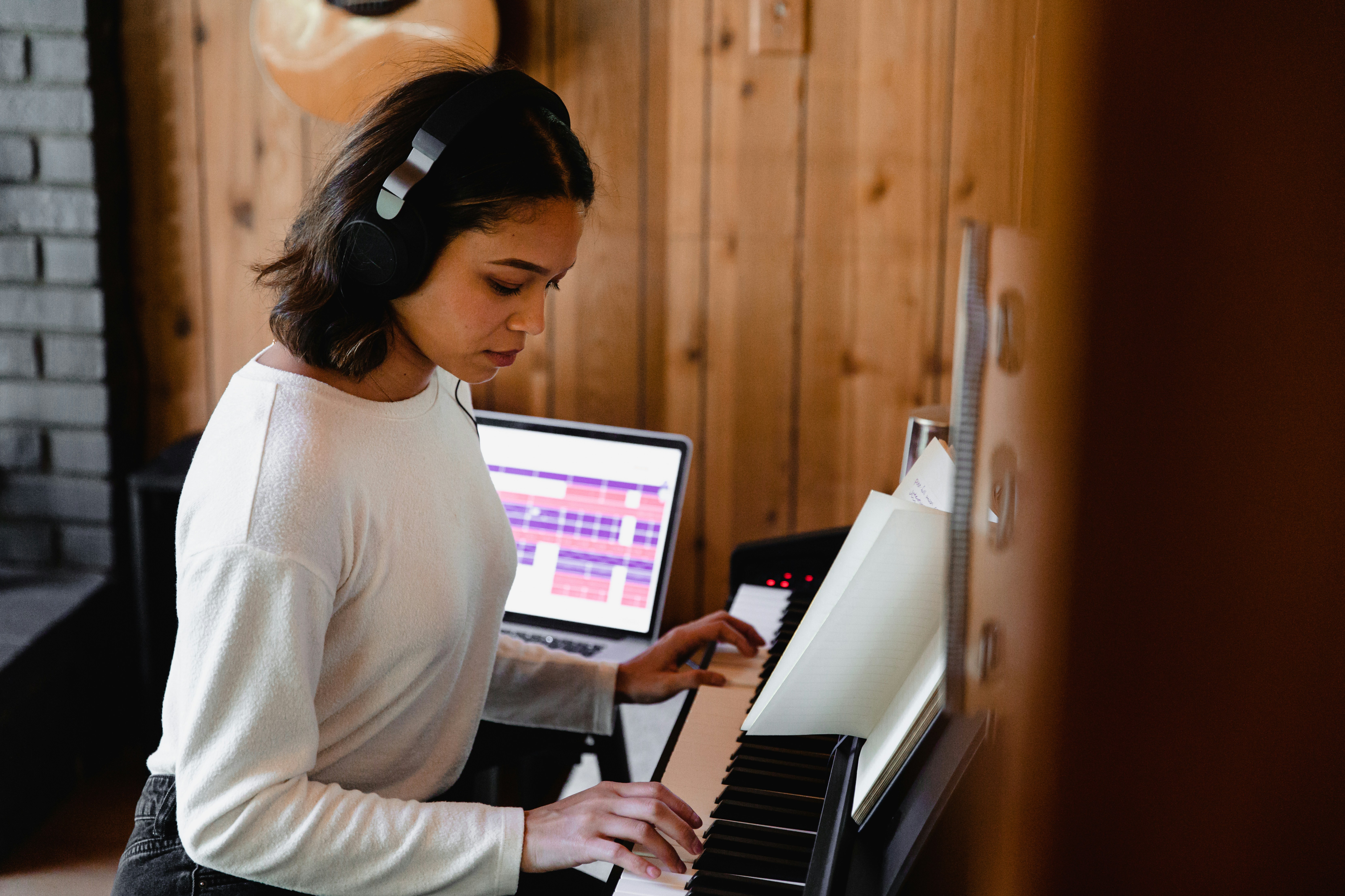 Woman playing chords on an electric piano