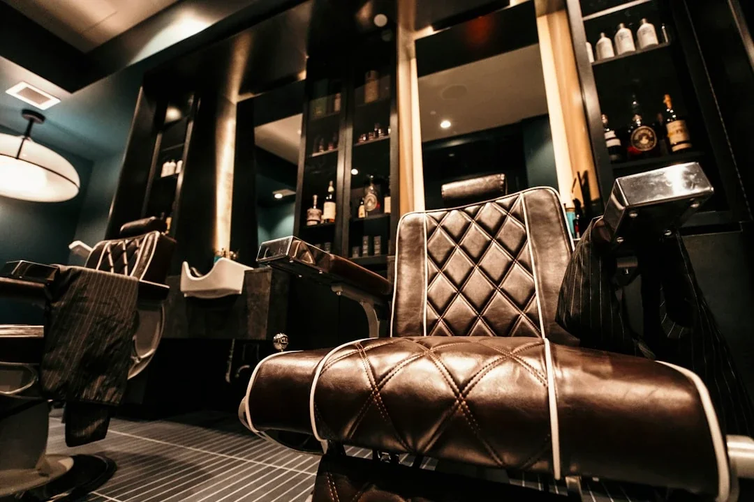 a barber shop with a chair and a mirror