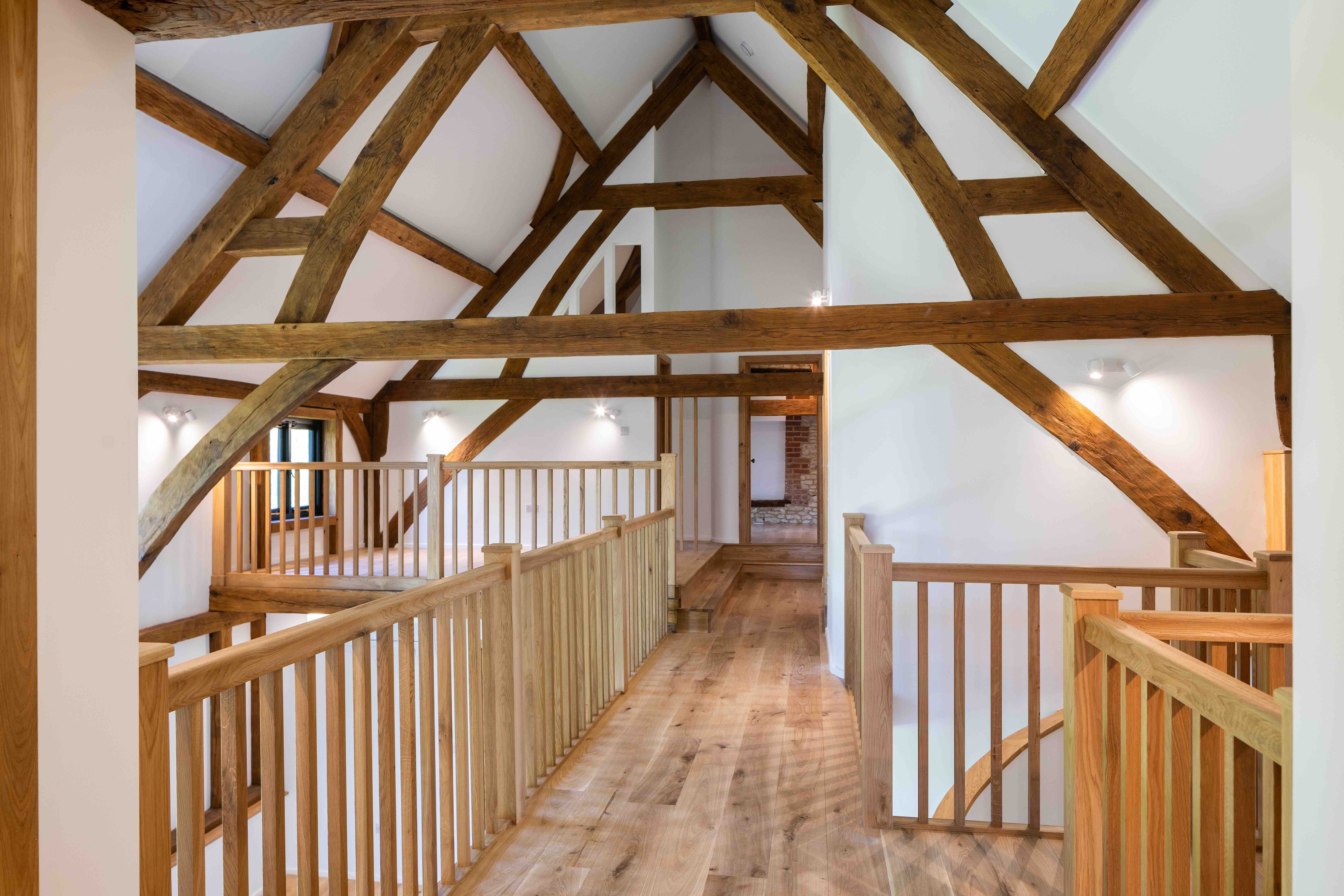     External view of oak-framed barn reconstruction, re-establishing the character of a historic agricultural building in Oxfordshire