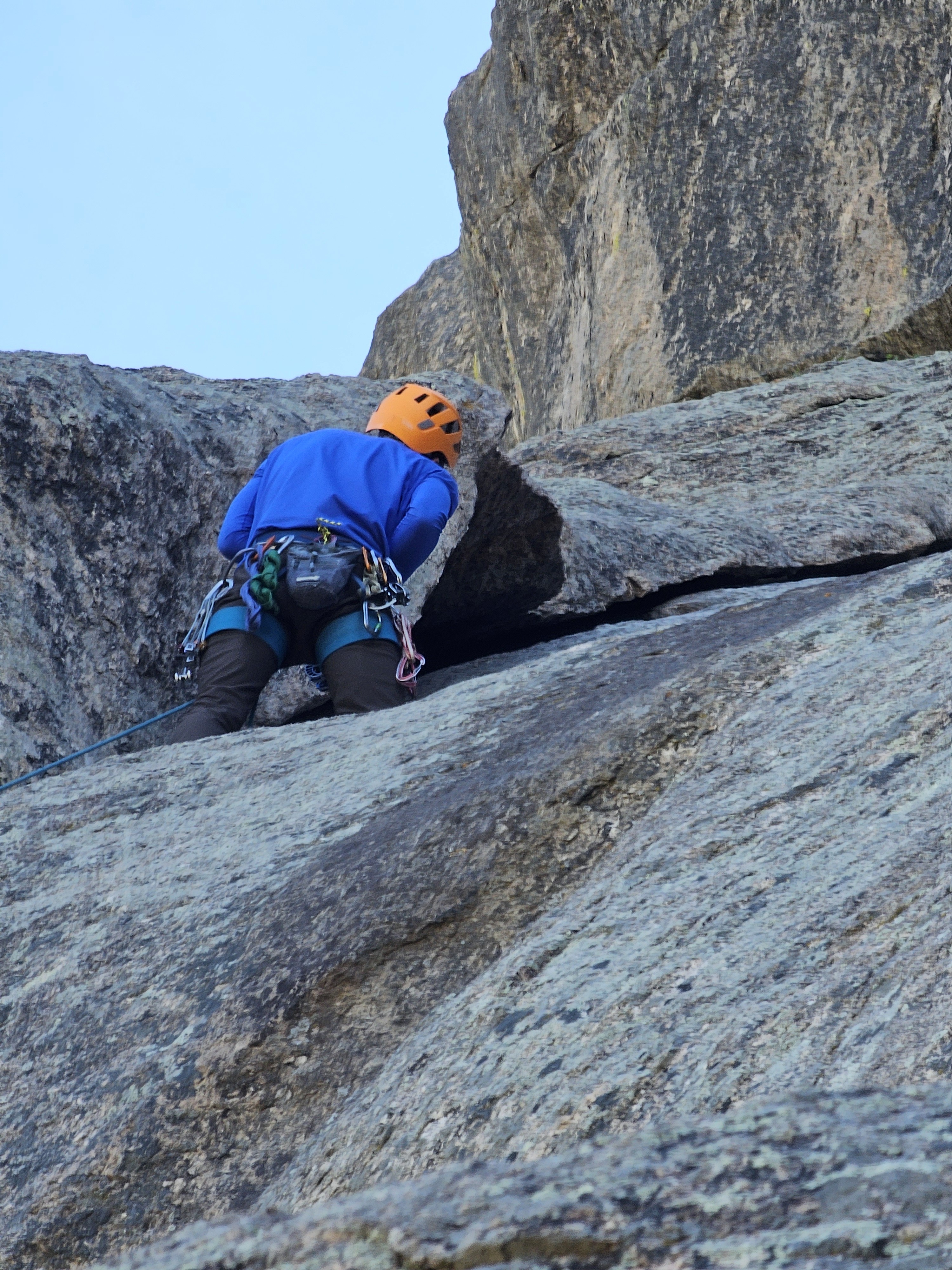 Client looks for a gear placement as they lead up The Pear in Lumpy Ridge