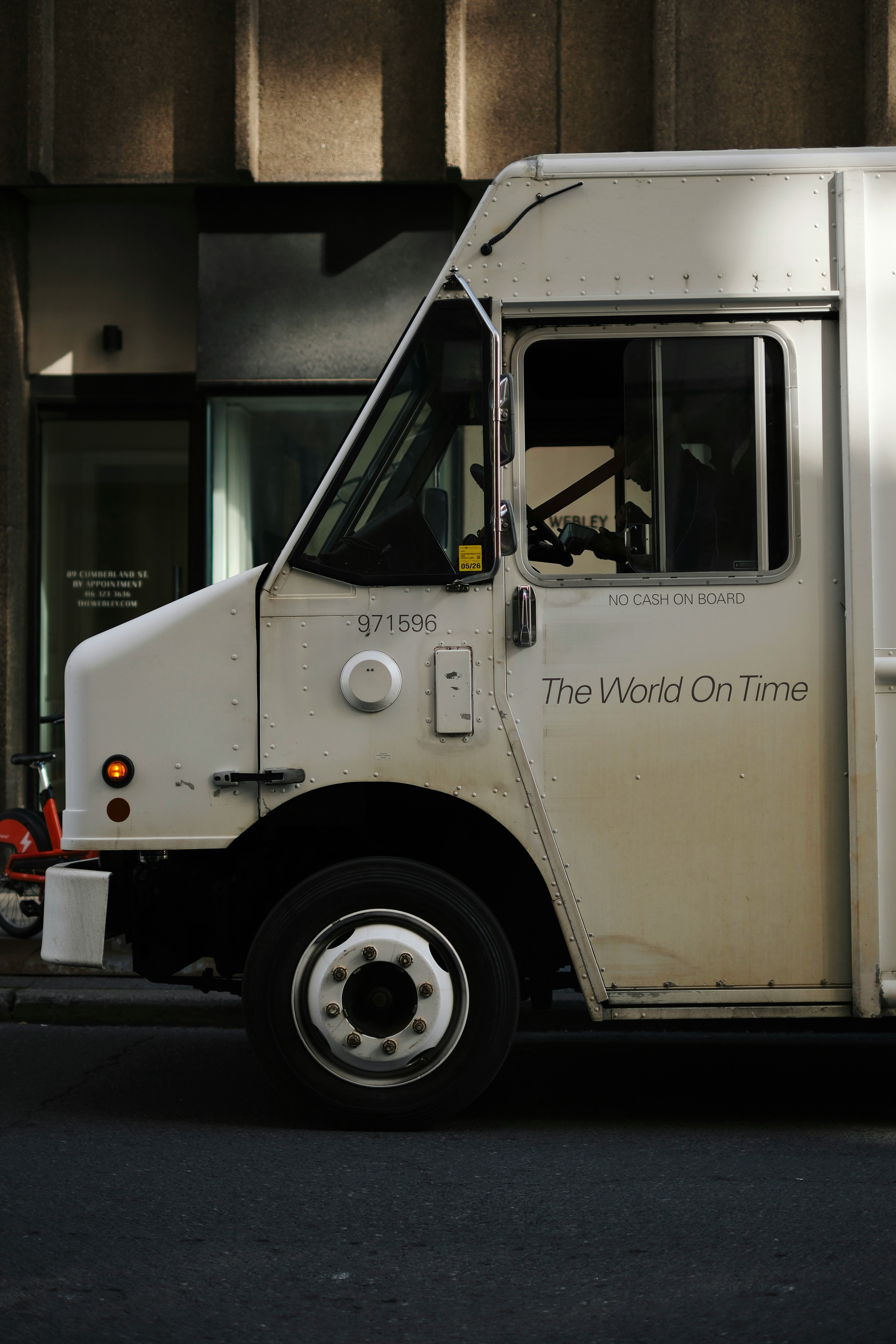 White delivery truck with "the world on time" text.